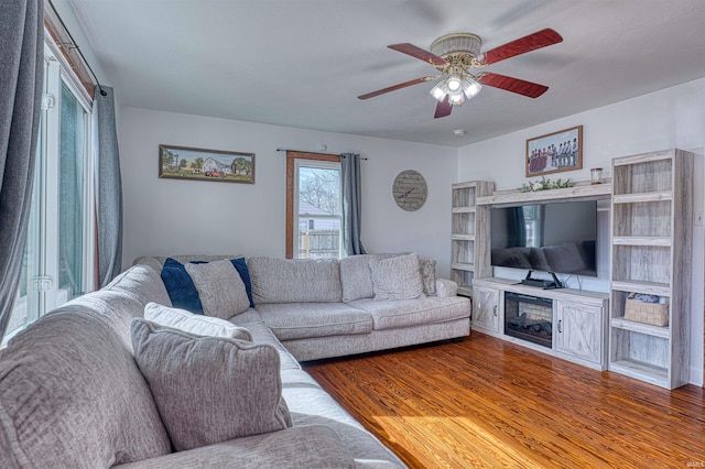 living area with ceiling fan and wood finished floors