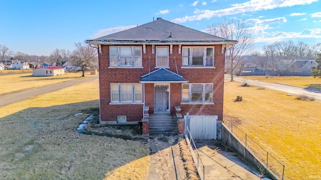 view of front of property featuring a front yard and brick siding