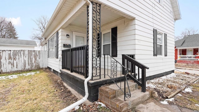 doorway to property featuring fence