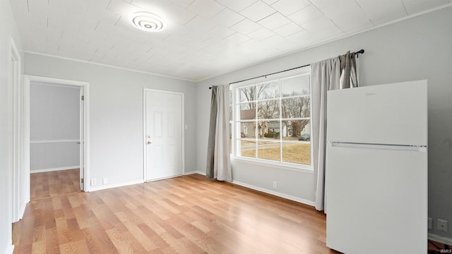 interior space featuring light wood-style floors and baseboards