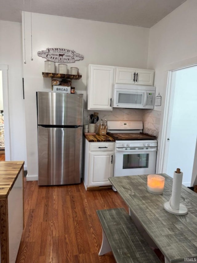 kitchen with white appliances, tasteful backsplash, white cabinets, and dark wood-style flooring