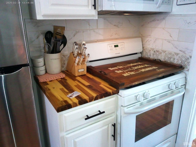 kitchen featuring tasteful backsplash, white appliances, wood counters, and white cabinets