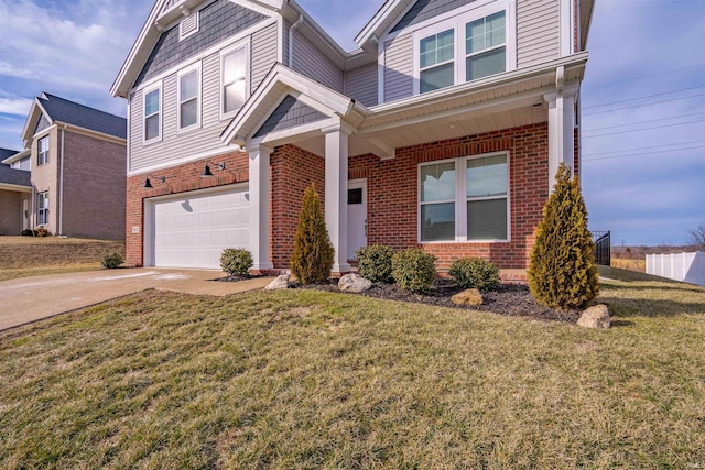 view of front of home with driveway, a garage, a front lawn, and brick siding