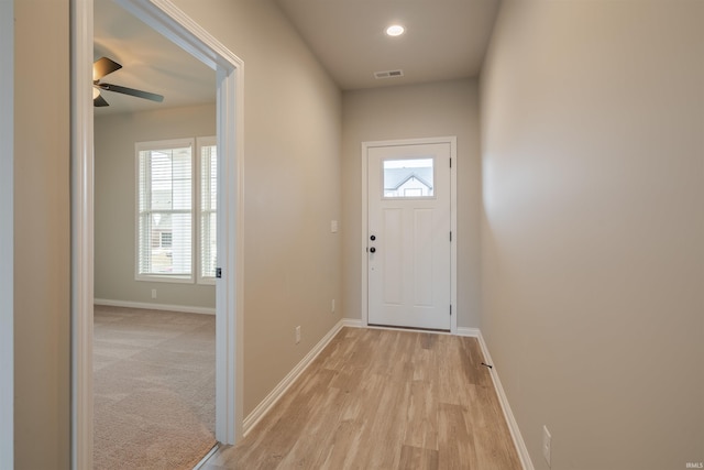 doorway to outside featuring plenty of natural light, baseboards, and ceiling fan