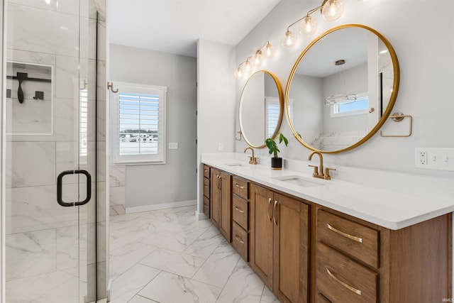 bathroom with a wealth of natural light, marble finish floor, a sink, and a shower stall