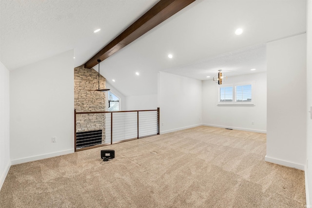 unfurnished living room featuring lofted ceiling with beams, a stone fireplace, recessed lighting, light colored carpet, and baseboards