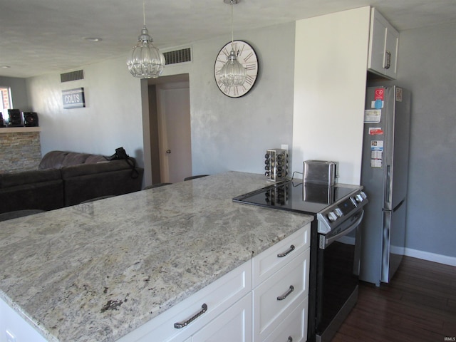 kitchen featuring stainless steel appliances, visible vents, white cabinets, hanging light fixtures, and light stone countertops