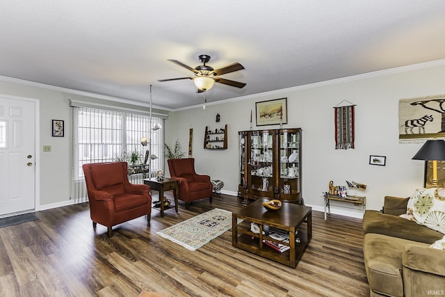 living area with crown molding, ceiling fan, a textured ceiling, wood finished floors, and baseboards