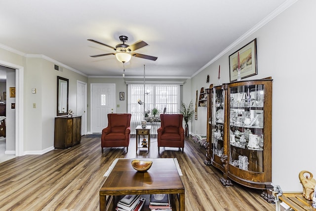 living room with wood finished floors and crown molding