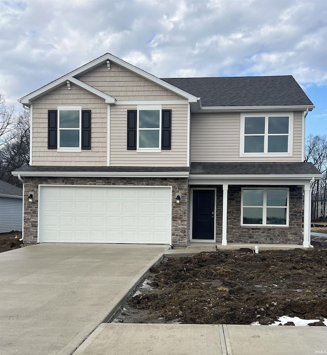 view of front of home with a garage, stone siding, and driveway