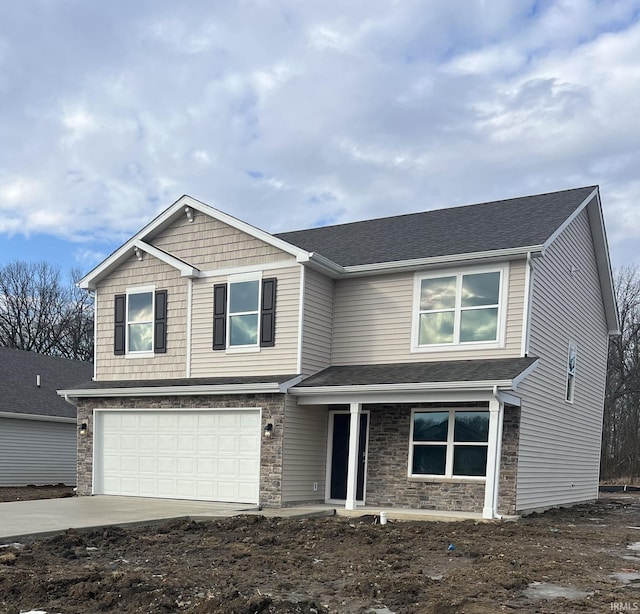 view of front of property with a garage, stone siding, a shingled roof, and driveway