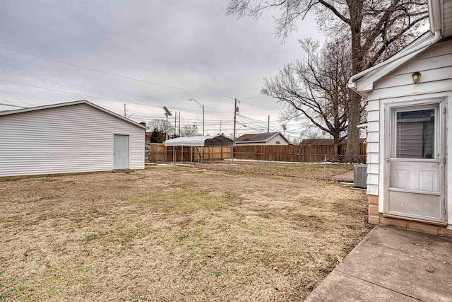 view of yard featuring a fenced backyard, cooling unit, and an outdoor structure