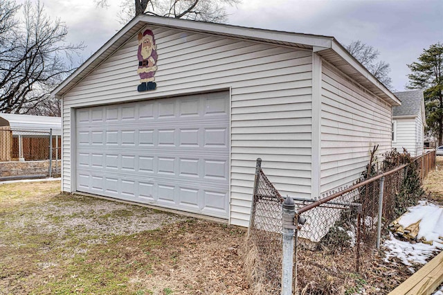 detached garage featuring fence