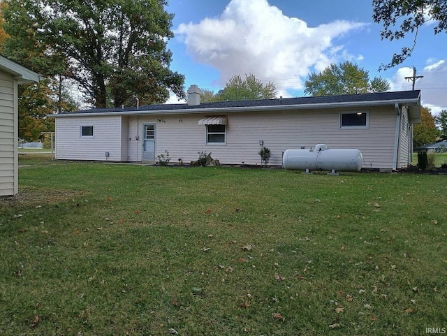 back of property featuring a lawn