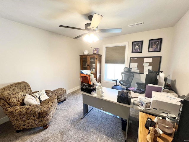 office area featuring baseboards, carpet, visible vents, and a ceiling fan