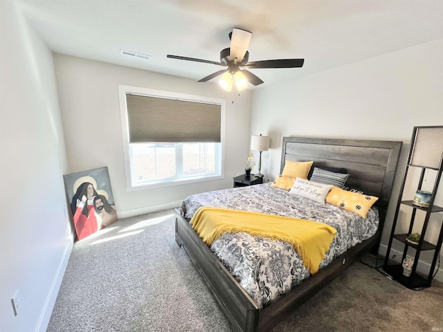 carpeted bedroom featuring a ceiling fan, visible vents, and baseboards