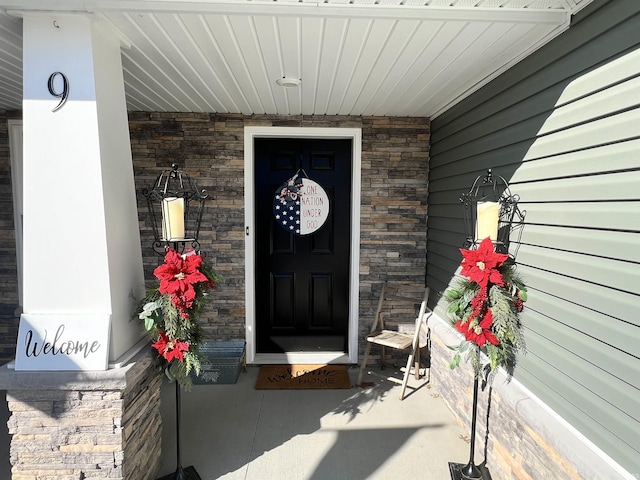 entrance to property featuring stone siding