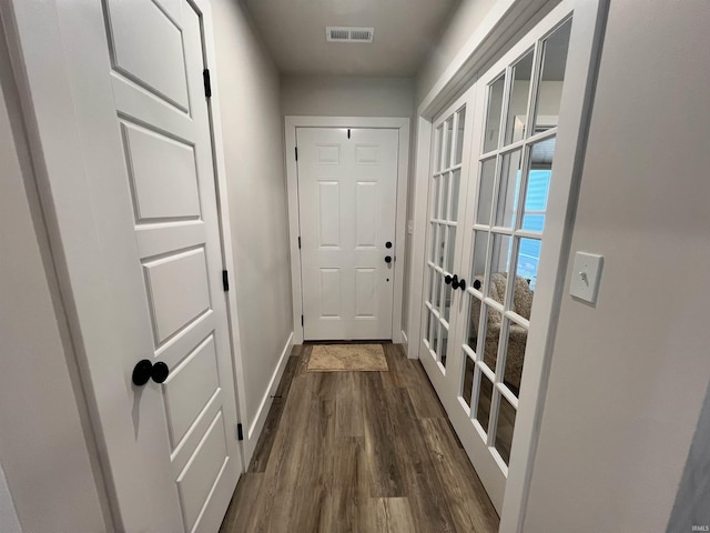 doorway to outside featuring french doors, dark wood-style flooring, visible vents, and baseboards