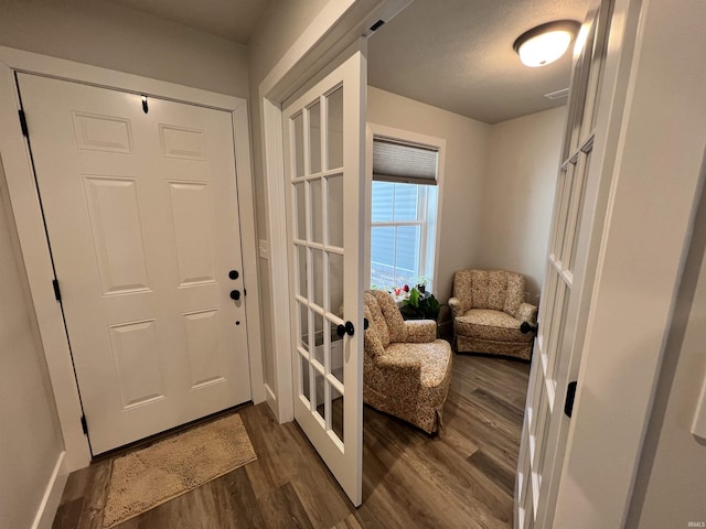 entrance foyer with french doors and dark wood-style flooring