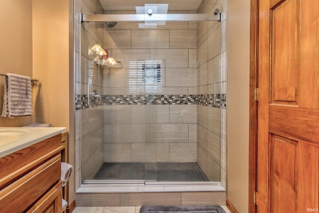 bathroom with vanity and a shower stall