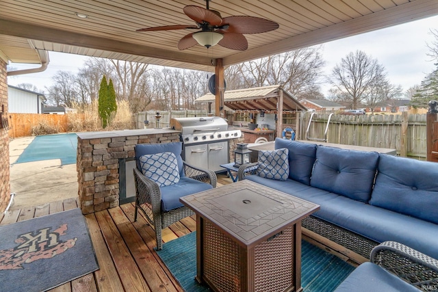 wooden deck featuring a fenced backyard, area for grilling, an outdoor living space, a ceiling fan, and a fenced in pool