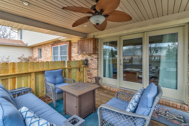 wooden terrace with ceiling fan and an outdoor living space