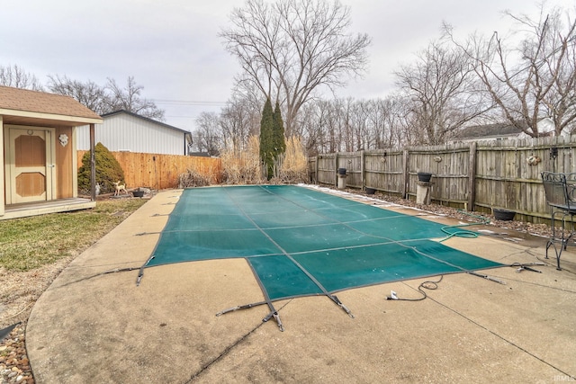 view of swimming pool featuring a patio, a fenced backyard, and a fenced in pool