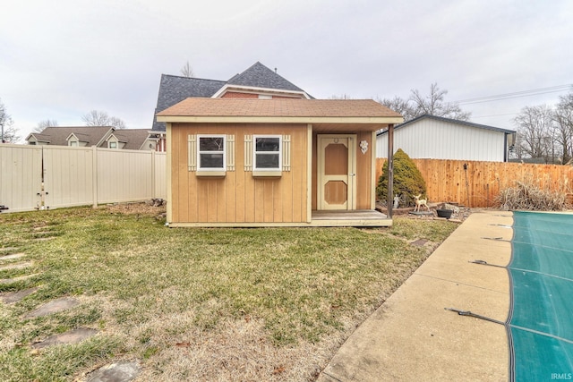 view of shed featuring a fenced backyard and a swimming pool