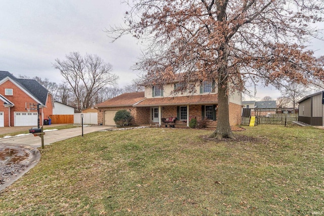 view of front facade with an attached garage, brick siding, a front yard, and fence