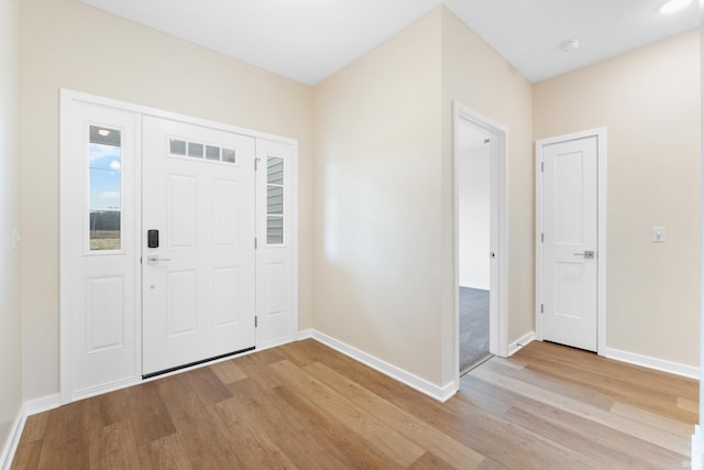 entryway with light wood-type flooring and baseboards