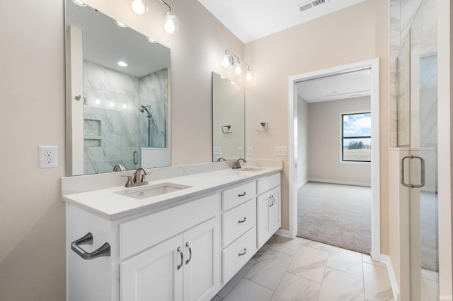 bathroom featuring marble finish floor, a shower stall, visible vents, and a sink