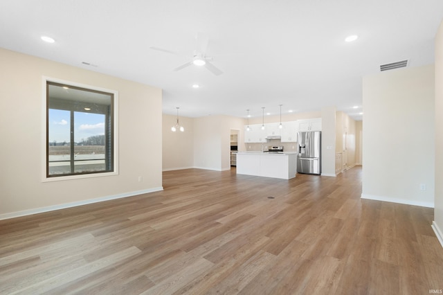 unfurnished living room with recessed lighting, light wood-type flooring, visible vents, and a ceiling fan