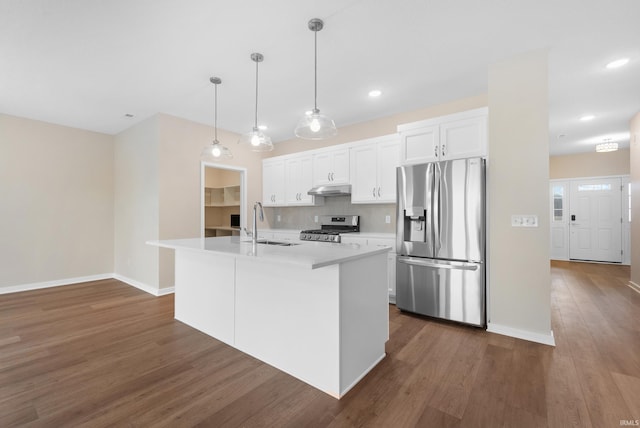 kitchen featuring stainless steel appliances, a kitchen island with sink, white cabinetry, and under cabinet range hood