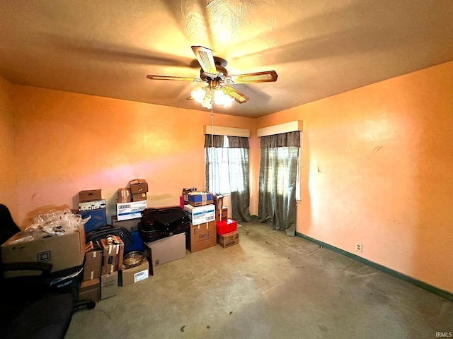 interior space with ceiling fan and baseboards