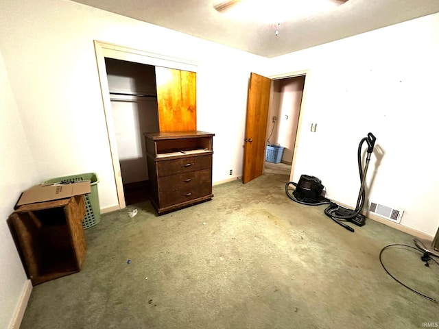 bedroom with light colored carpet, a closet, visible vents, and baseboards