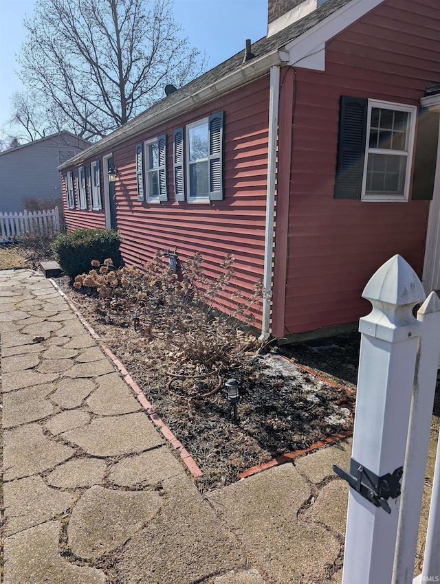 view of side of property featuring fence