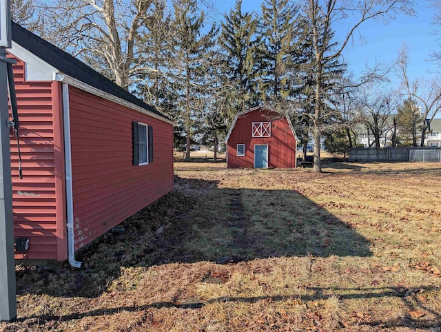 view of yard with fence and an outdoor structure