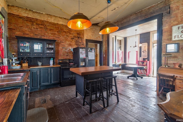 kitchen with dark wood-style floors, pendant lighting, blue cabinets, butcher block countertops, and black appliances