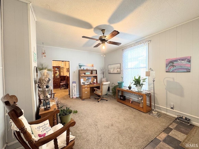 sitting room with a textured ceiling, carpet, a ceiling fan, and baseboards