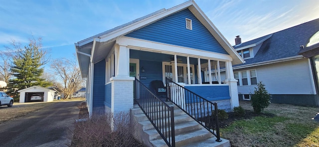 bungalow-style home with covered porch and a garage