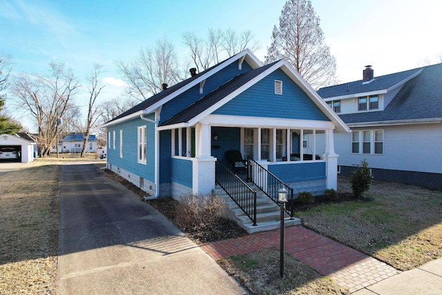 bungalow with covered porch and driveway