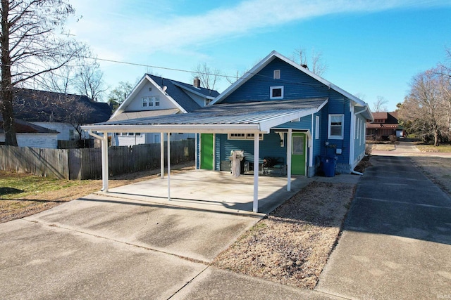 bungalow with fence and a carport