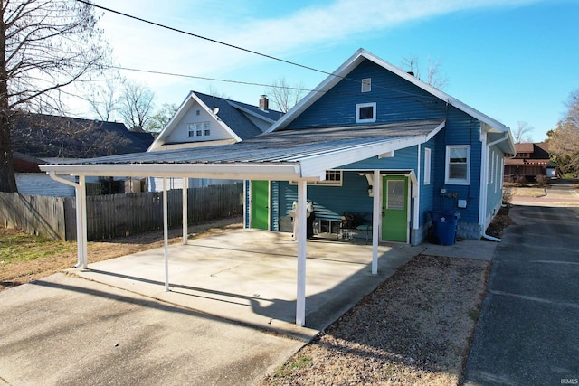 exterior space featuring fence and a carport