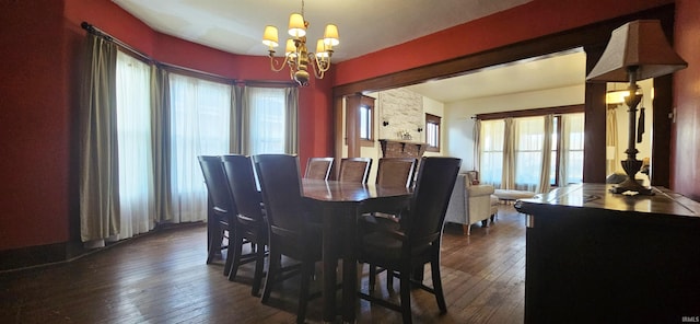 dining space featuring a chandelier and dark wood-style flooring