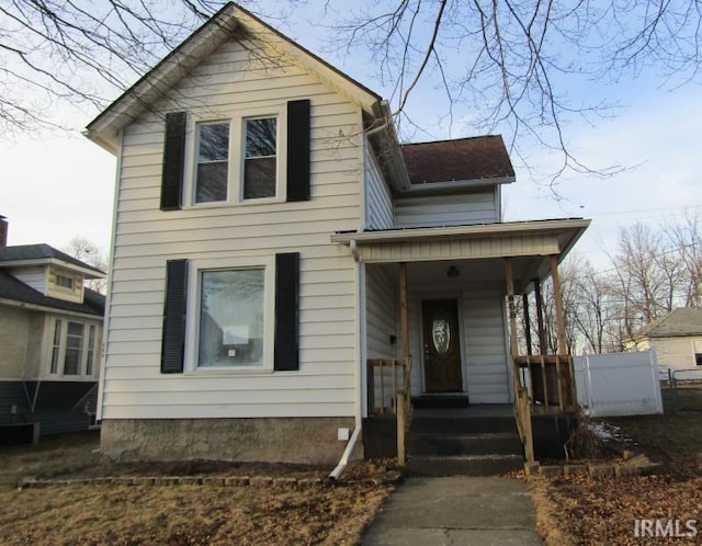 traditional home featuring covered porch