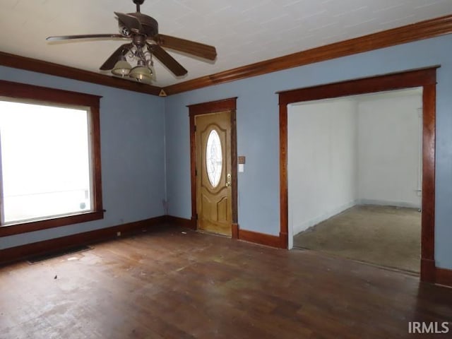 entryway with dark wood finished floors, visible vents, ornamental molding, ceiling fan, and baseboards