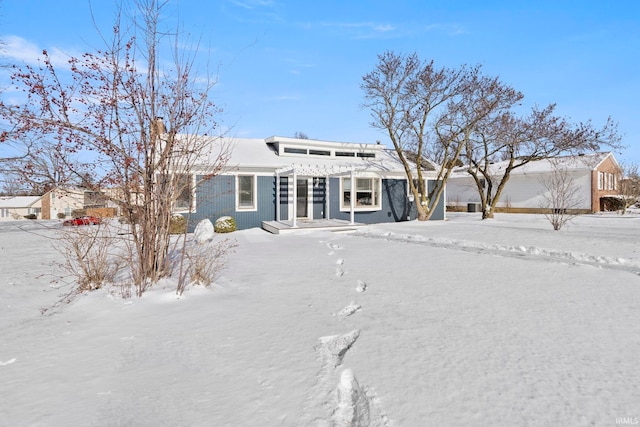 view of front of property featuring a garage and a pergola