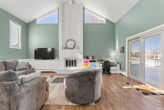 living room with a baseboard radiator, a brick fireplace, plenty of natural light, and wood finished floors