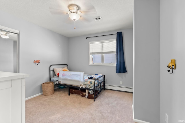 bedroom featuring a textured ceiling, a baseboard radiator, light carpet, visible vents, and baseboards