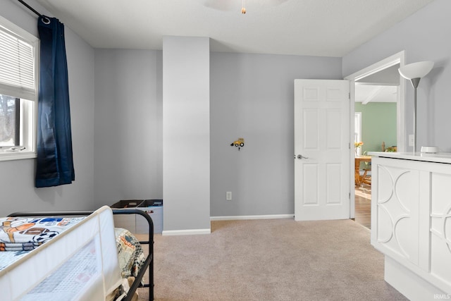 bedroom with light carpet and baseboards